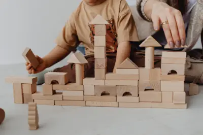 A mother and her child playing with building blocks